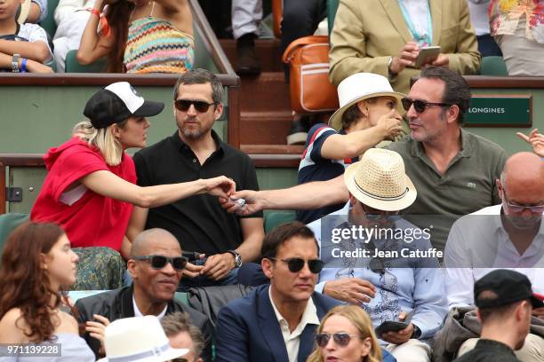 Marion Cotillard, her husband Guillaume Canet, Jean Dujardin during the men's final on Day 15 of the 2018 French Open at Roland Garros stadium on...