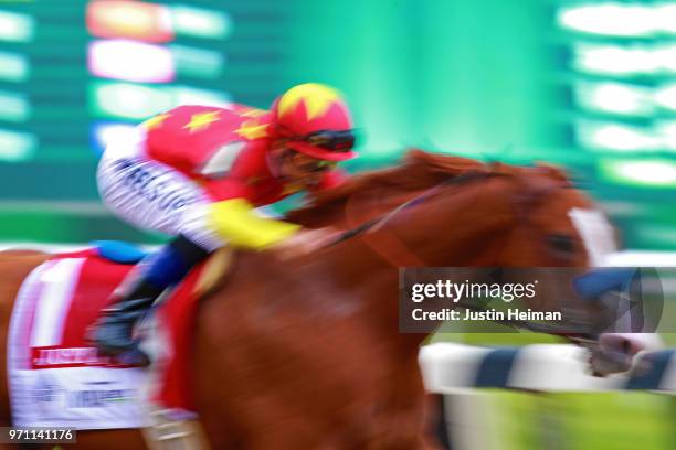 Justify, ridden by jockey Mike Smith leads the field to the finish line to win the 150th running of the Belmont Stakes at Belmont Park on June 9,...