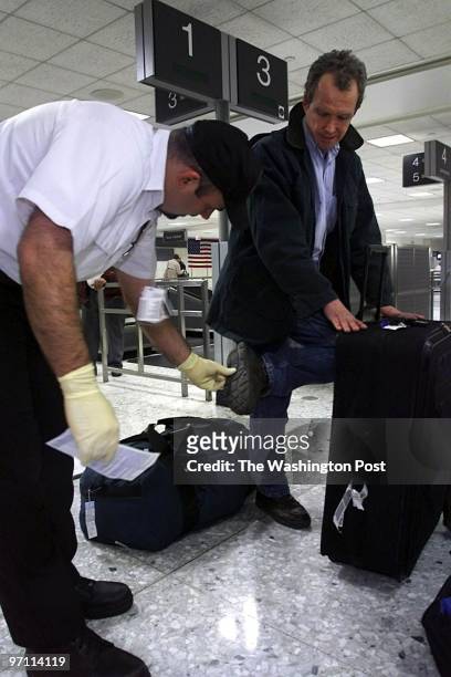 Passangers at the International Arrivals Terminal at Dulles Airport. This is Tony Roman Senior PPQ Officer . He is examining the shoes of Tom...