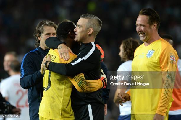 David Harewood shares a laugh with Robbie Williams and David Seaman after the final whistle during Soccer Aid for Unicef 2018 at Old Trafford on June...