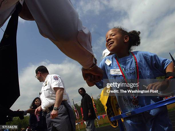 Year old Elizabeth Harrington receives her medal from Maj. Marcus Summers of the Prince George's County Police Dept. After participating in the...