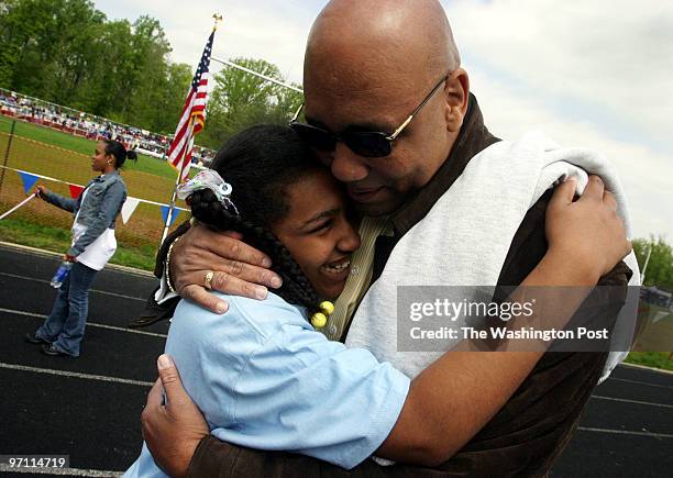 Kailah Clark, a student at High Bridge Elementary School gets a supportive hug from her dad Roger Clark after she placed second in the 50 meter dash...