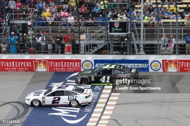 Brad Keselowski , driver of the Miller Lite Ford, and Kurt Busch , driver of the Monster Energy/Haas Automation Ford, race during the Monster Energy...