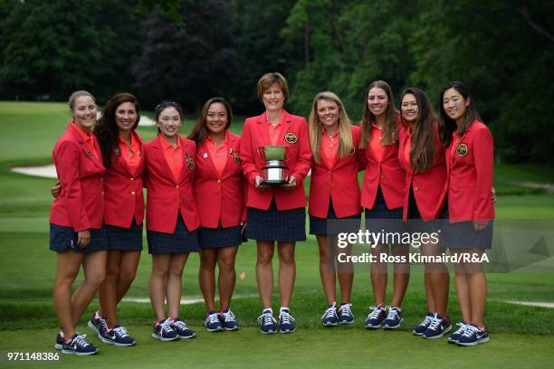 The United States team and Captain Virginia Derby Grimes celebrate with the Curtis Cup trophy after their 17-3 win over the Great Britain and Ireland...