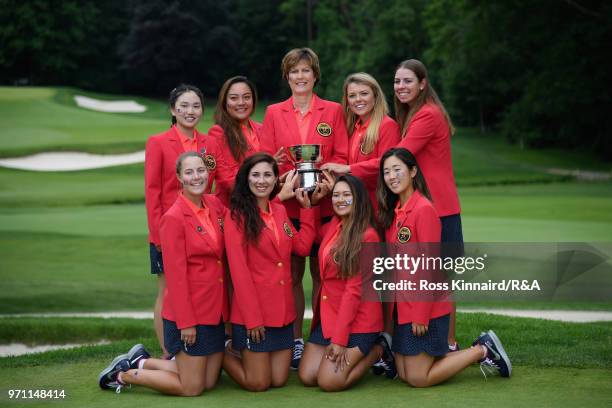The United States team and Captain Virginia Derby Grimes celebrate with the Curtis Cup trophy after their 17-3 win over the Great Britain and Ireland...