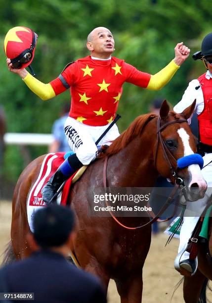 Jockey Mike Smith celebrates atop of Justify during the 150th running of the Belmont Stakes at Belmont Park on June 9, 2018 in Elmont, New York....