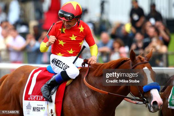 Jockey Mike Smith celebrates atop of Justify during the 150th running of the Belmont Stakes at Belmont Park on June 9, 2018 in Elmont, New York....