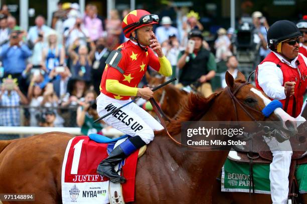 Jockey Mike Smith celebrates atop of Justify during the 150th running of the Belmont Stakes at Belmont Park on June 9, 2018 in Elmont, New York....