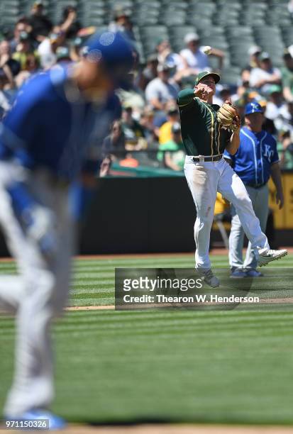 Matt Chapman of the Oakland Athletics thows to first base off balance throwing out Paulo Orlando of the Kansas City Royals in the top of the six...