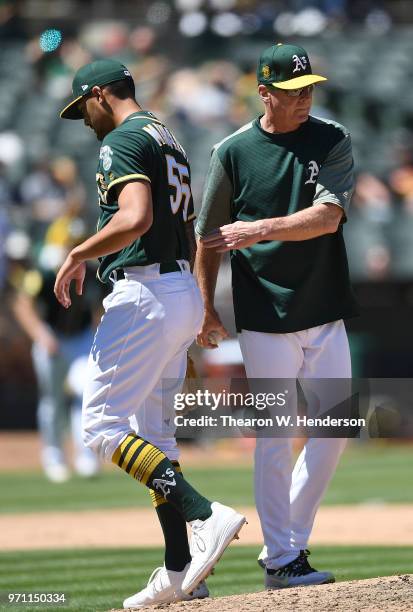 Manager Bob Melvin of the Oakland Athletics takes the ball from starting pitcher Sean Manaea taking Manaea out of the game against the Kansas City...