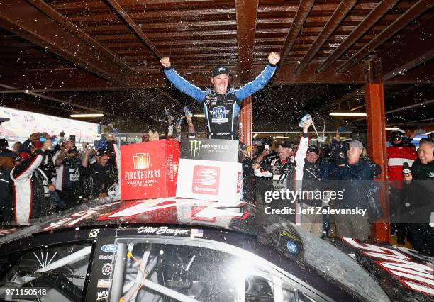 Clint Bowyer, driver of the Haas 30 Years of the VF1 Ford, celebrates after winning the Monster Energy NASCAR Cup Series FireKeepers Casino 400 at...