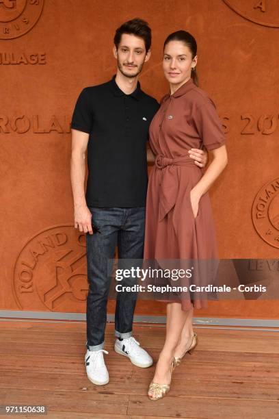 Actors Pierre Niney and Natasha Andrews attend the Men Final of the 2018 French Open - Day Fifteen at Roland Garros on June 10, 2018 in Paris, France.