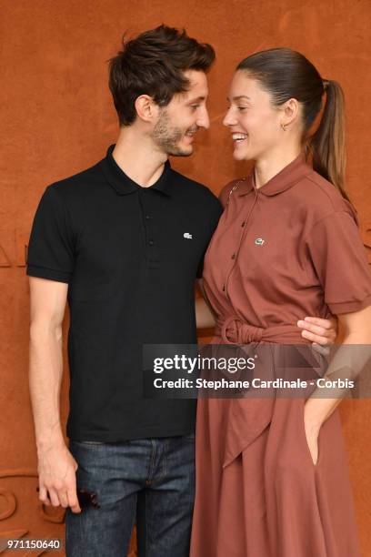 Actors Pierre Niney and Natasha Andrews attend the Men Final of the 2018 French Open - Day Fifteen at Roland Garros on June 10, 2018 in Paris, France.