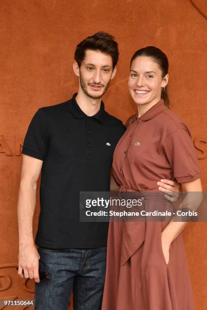 Actors Pierre Niney and Natasha Andrews attend the Men Final of the 2018 French Open - Day Fifteen at Roland Garros on June 10, 2018 in Paris, France.