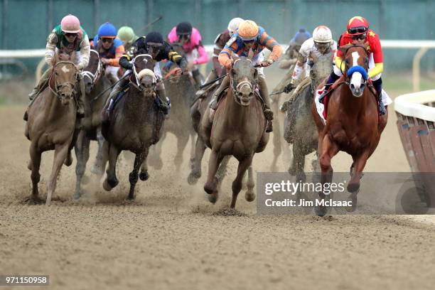 Justify, ridden by jockey Mike Smith leads the field around the 4th turn during the 150th running of the Belmont Stakes at Belmont Park on June 9,...