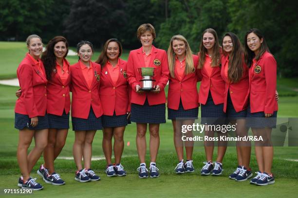 The United States team and Captain Virginia Derby Grimes celebrate with the Curtis Cup trophy after their 17-3 win over the Great Britain and Ireland...