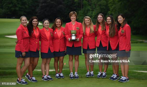 The United States team and Captain Virginia Derby Grimes celebrate with the Curtis Cup trophy after their 17-3 win over the Great Britain and Ireland...