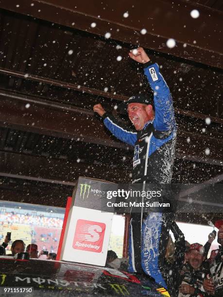 Clint Bowyer, driver of the Haas 30 Years of the VF1 Ford, celebrates after winning the Monster Energy NASCAR Cup Series FireKeepers Casino 400 at...