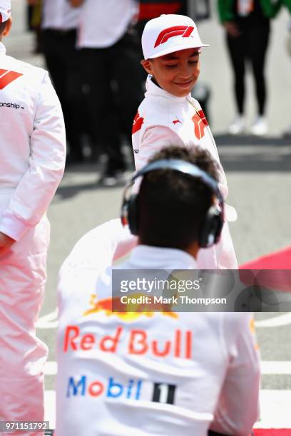 Grid kid talks with Daniel Ricciardo of Australia and Red Bull Racing on the grid before the Canadian Formula One Grand Prix at Circuit Gilles...