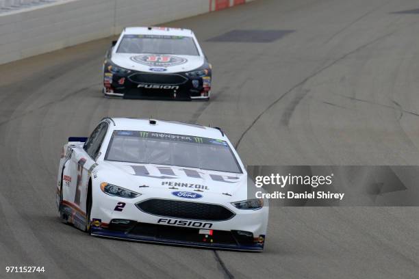 Brad Keselowski, driver of the Miller Lite Ford, leads Kevin Harvick, driver of the Jimmy John's Ford, during the Monster Energy NASCAR Cup Series...