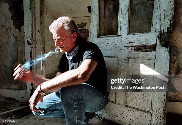 Randy Weaver takes a drag on his cigarette as he pauses in a moment of contemplation in an abandoned farm house near his home in Jefferson, Iowa....