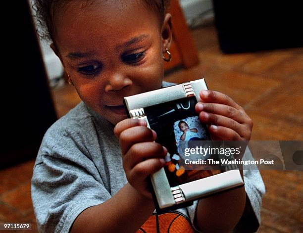 Anika Perry holds a photo of her twin sister Tyrika, a medically fragile infant who died in her playpen after the hospital put the twins into the...