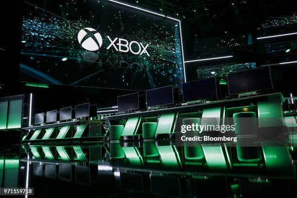 The Xbox logo is displayed on a screen behind monitors on stage during of the Microsoft Corp. Xbox event ahead of the E3 Electronic Entertainment...