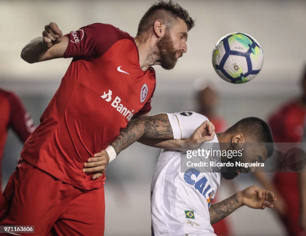 Gabriel of Santos battles for the ball with Leismann of Internacional during a match between Santos and Internacional as a part of Campeonato...