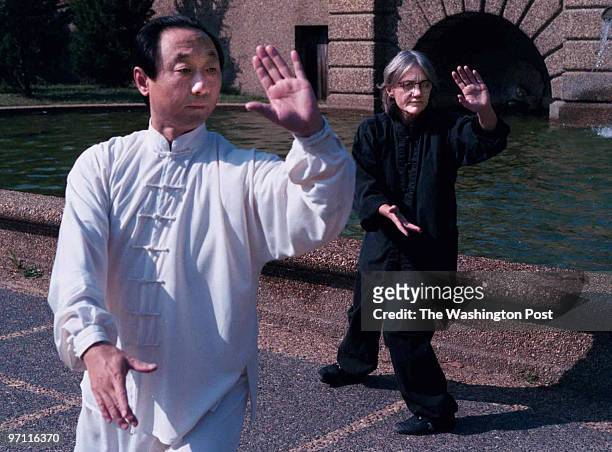 Dc/connolly, 10/02/01, by Larry Morris TWP Camille Connolly practicing with her tai chi master Xiao Ling Liu in Meridian Hill Park Original Filename:...