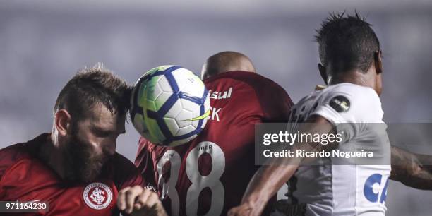 Bruno Henrique of Santos battles for the ball with Patrick and leismann of Internacional during the match between Santos and Internacional as a part...