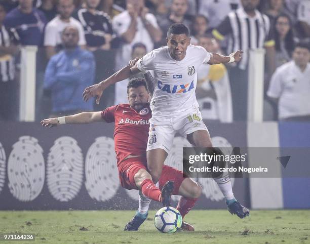 David Braz of Santos battles for the ball with Iago of Internacional during the match between Santos and Internacional as a part of Campeonato...