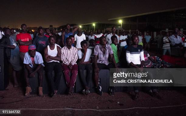 People watch a documentary called "Number 12" by investigative journalist Anas Aremeyaw Anas about former Ghanian Football Association president...