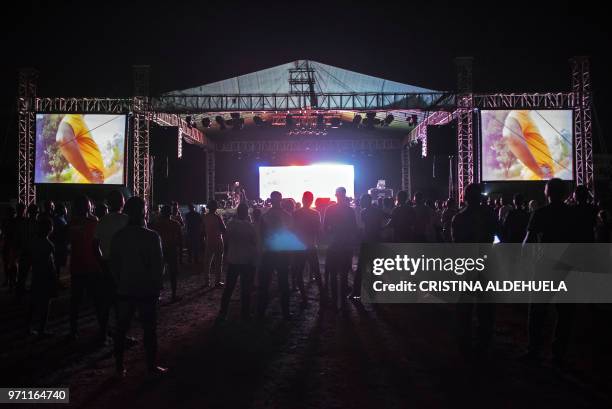 People watch a documentary called "Number 12" by investigative journalist Anas Aremeyaw Anas about former Ghanian Football Association president...