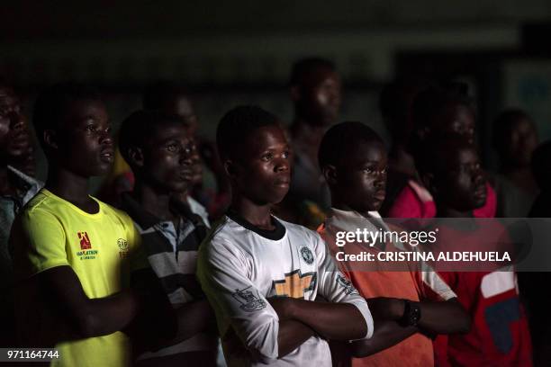 People watch a documentary called "Number 12" by investigative journalist Anas Aremeyaw Anas about former Ghanian Football Association president...