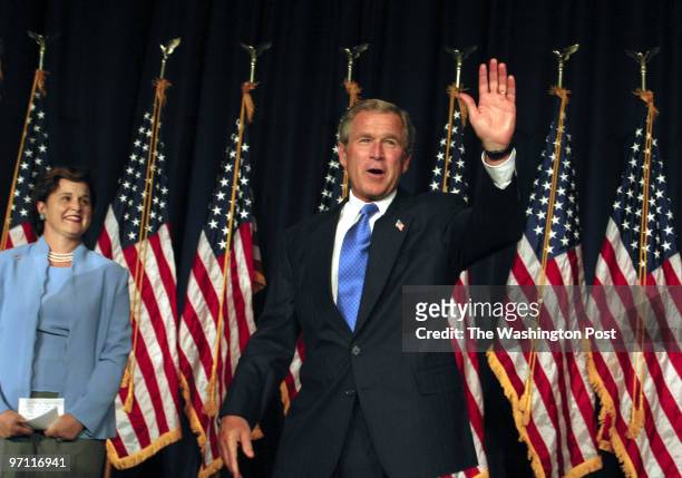 Bush receives a warm welcome as he enters the ballroom. At left is Bush's sister Doro Koch who introduced him.