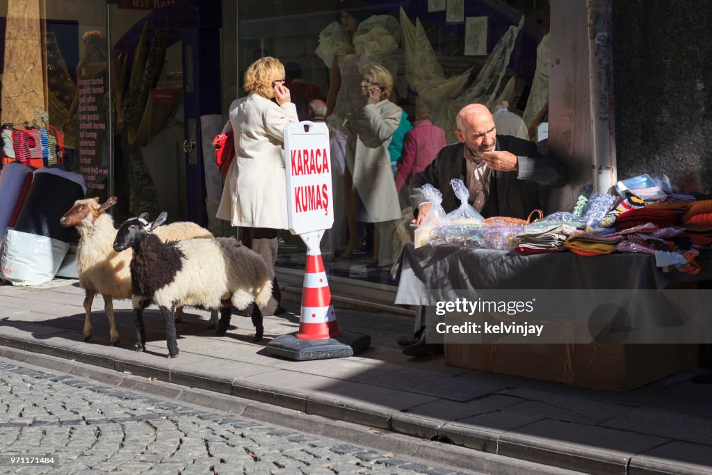 Pedestrians walking past shops in the street in Istanbul, Turkey