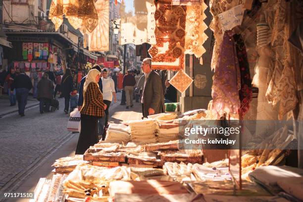 shopkeeper and customer talking in the street in istanbul, turkey - kelvinjay stock pictures, royalty-free photos & images
