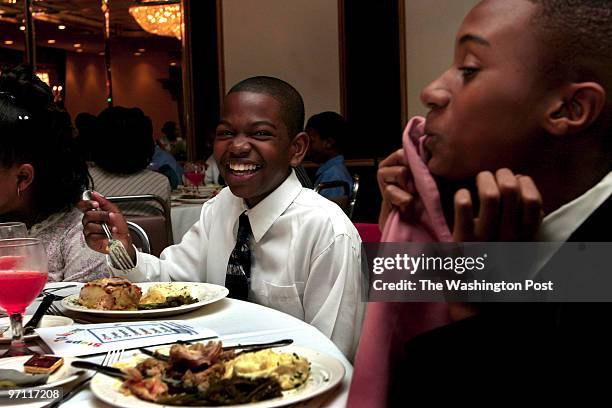 Students of Dolores Hawkins practice what they learned about etiquette at a luncheon at La Fontaine Bleu restaurant. Left to rt: Keenan Lee 12 laughs...