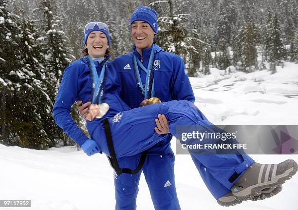 France's medalists Marie-Laure Brunet and Vincent Jay pose at Whistler Olympic Park during the Vancouver Winter Olympics on February 26, 2010. AFP...