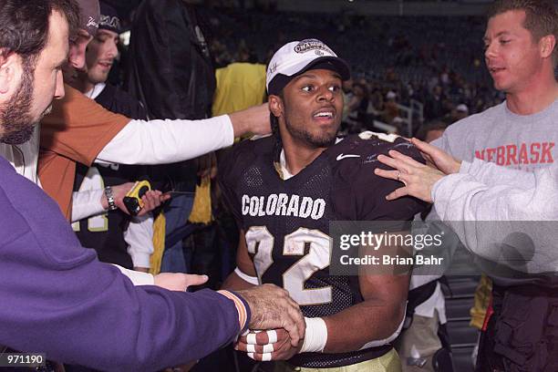 Tailback Chris Brown of the Colorado Buffalos is congratulated after the victory against the Texas Longhorns in the Big 12 Championship game on...