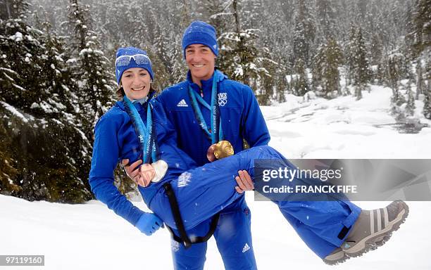 France's biathlon medalists Marie-Laure Brunet and Vincent Jay pose with their medals in Whistler on February 26, 2010 during the Vancouver Winter...