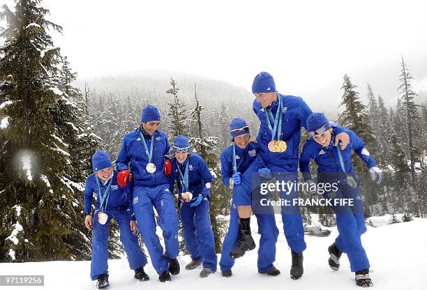 France's biathlon medalists Marie Dorin, Martin Fourcade, Marie Laure Brunet, Sylvie Becaert, Vincent Jay and Sandrine Bailly joke as they pose in...