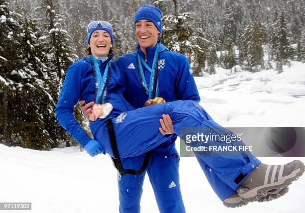 France's biathlon medalists Marie-Laure Brunet and Vincent Jay pose with their medals in Whistler on February 26, 2010 during the Vancouver Winter...