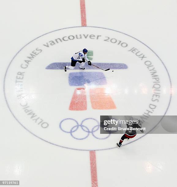Joni Pitkanen of Finland moves the puck during the ice hockey men's semifinal game between the United States and Finland on day 15 of the Vancouver...