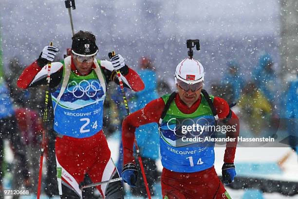 Christoph Sumann of Austria and Ole Einar Bjoerndalen of Norway compete during the men's 4 x 7.5 km biathlon relay on day 15 of the 2010 Vancouver...