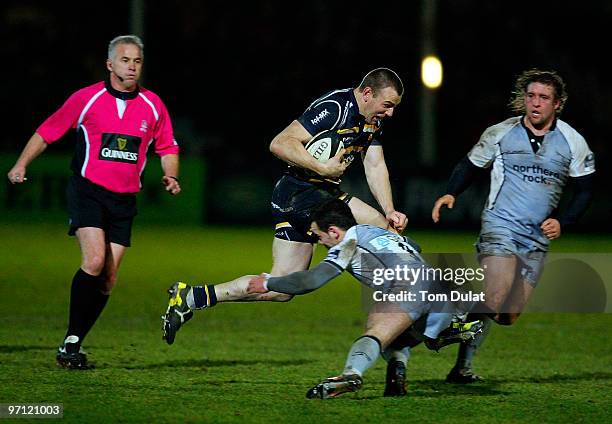 Micky Young of Newcastle Falcons attempts to stop Chris Latham of Worcester Warriors running with the ball during the Guinness Premiership match...