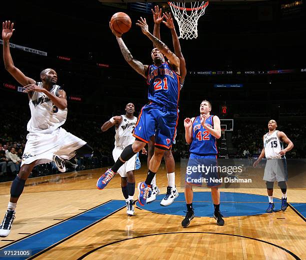 Wilson Chandler of the New York Knicks shoots against Quinton Ross of the Washington Wizards at the Verizon Center on February 26, 2010 in...