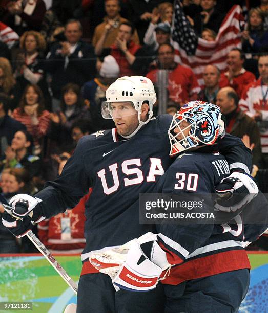 S goalkeeper Tim Thomas celebrates with a team mate their win over Finland during the Men's Semifinals Medal Hockey game between the USA and Finland...