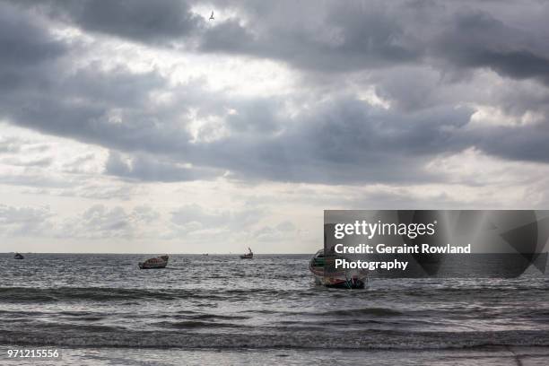 fishing boats on the water, tanjil - geraint rowland stock pictures, royalty-free photos & images