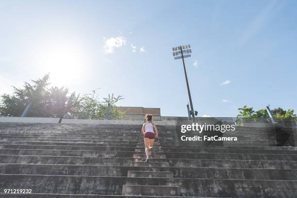 female exercising in stadium - unapologetic stock pictures, royalty-free photos & images